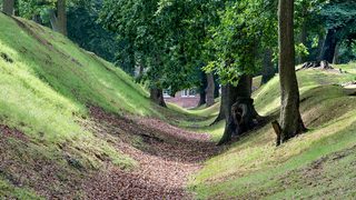 © Crown Copyright HES. Watling Lodge, a steep bank on the right with a leaf strewn ditch below, a lower bank to the left and trees on either side. © Crown Copyright HES. Watling Lodge, a steep bank on the right with a leaf strewn ditch below, a lower bank to the left and trees on either side.