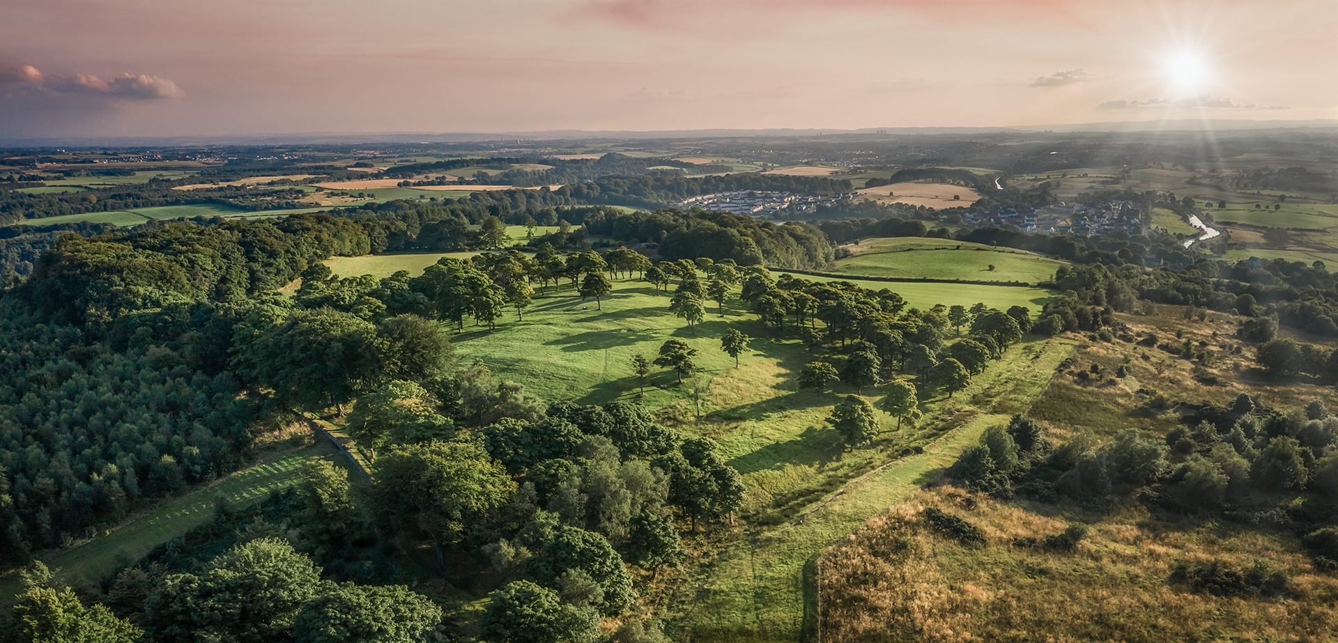© Rediscovering the Antonine Wall Project
Bar Hill fort, a green, wooded hilltop from above. Rolling hills with the setting sun and wispy clouds in a peach colour sky. © Rediscovering the Antonine Wall Project
Bar Hill fort, a green, wooded hilltop from above. Rolling hills with the setting sun and wispy clouds in a peach colour sky.