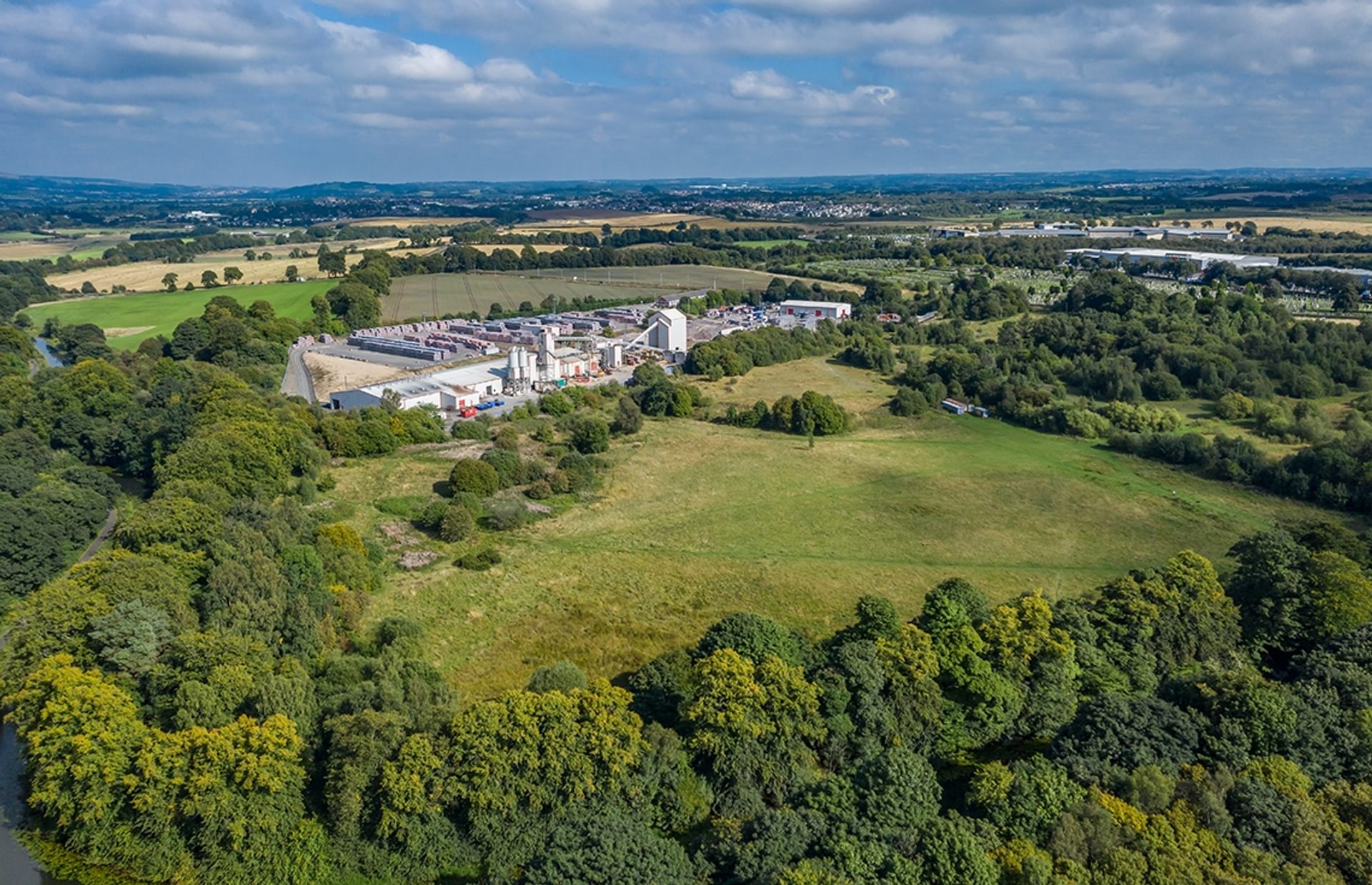 © Rediscovering the Antonine Wall Project
Cadder Fort site from above, fields and woodland with an area of industrial buildings next to it. Hills and blue sky beyond. © Rediscovering the Antonine Wall Project
Cadder Fort site from above, fields and woodland with an area of industrial buildings next to it. Hills and blue sky beyond.