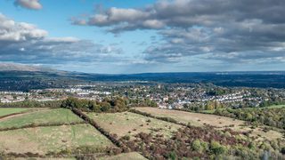 © Rediscovering the Antonine Wall Project
An expansive view of green fields and woodland and a town in the distance. The sky is blue, and full of silver edged clouds. © Rediscovering the Antonine Wall Project
An expansive view of green fields and woodland and a town in the distance. The sky is blue, and full of silver edged clouds.