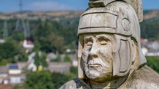 © Rediscovering the Antonine Wall Project
A wooden Roman soldier sculpture at Duntocher Play Park. It is sunny and there are houses and trees behind it. © Rediscovering the Antonine Wall Project
A wooden Roman soldier sculpture at Duntocher Play Park. It is sunny and there are houses and trees behind it.