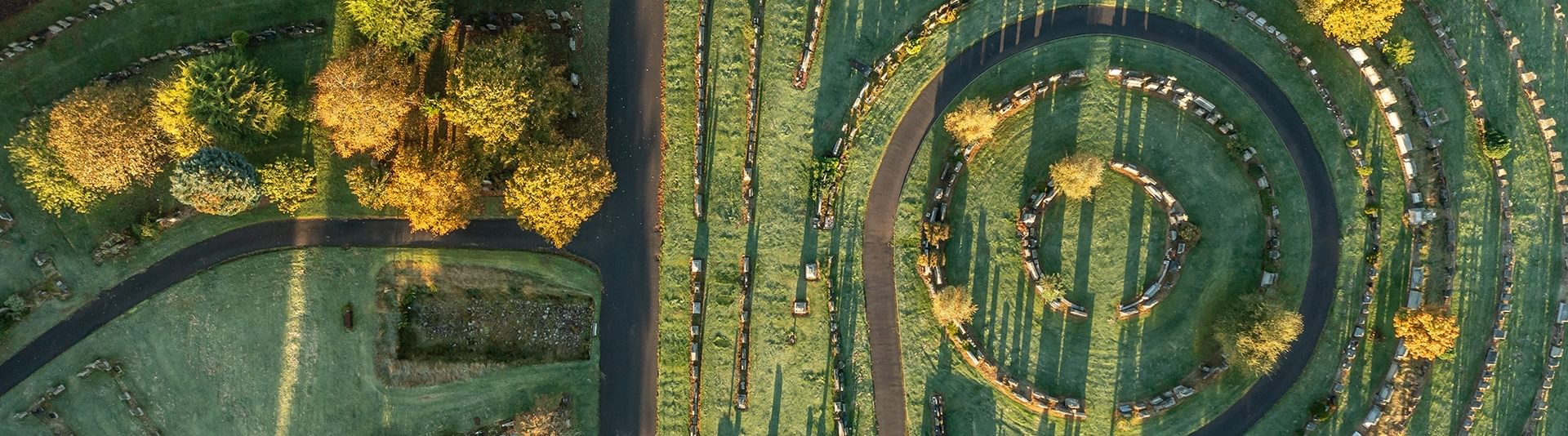© Rediscovering the Antonine Wall Project
New Kilpatrick Cemetery with a section of wall base from above. The graves have long shadows and are surrounded by trees. © Rediscovering the Antonine Wall Project
New Kilpatrick Cemetery with a section of wall base from above. The graves have long shadows and are surrounded by trees.