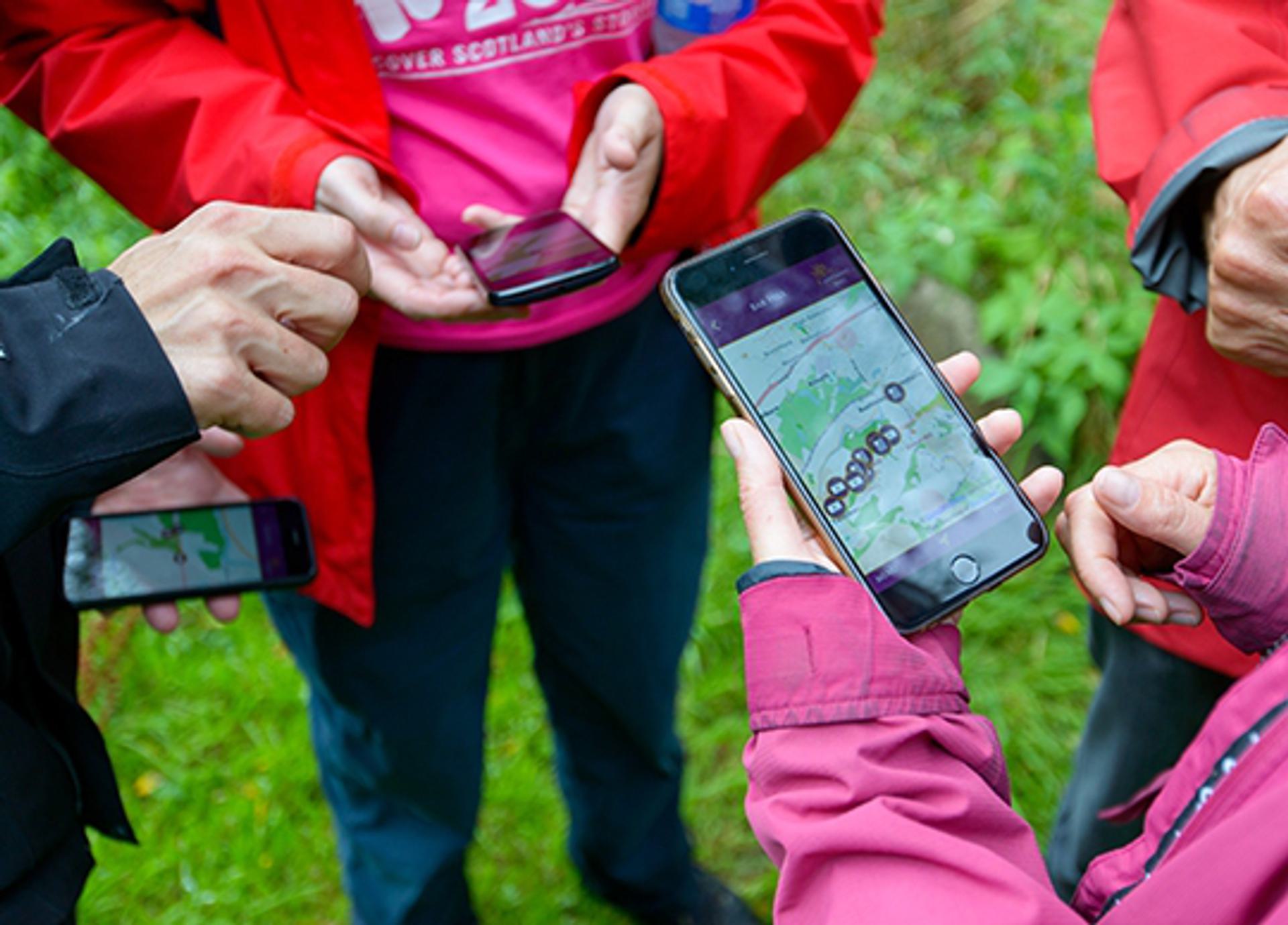 © Historic Environment Scotland
Three sets of hands seen from above. They hold mobile phones showing the Antonine Wall interactive map. © Historic Environment Scotland
Three sets of hands seen from above. They hold mobile phones showing the Antonine Wall interactive map.