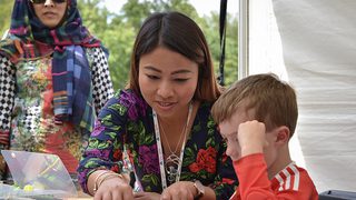 © Alastair Ross
Glasgow Mela 2019, a woman watches another woman and child at a table in a tent using Antonine Wall educational resources. © Alastair Ross
Glasgow Mela 2019, a woman watches another woman and child at a table in a tent using Antonine Wall educational resources.