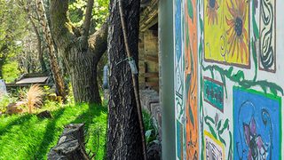 © Rediscovering the Antonine Wall Project
Bearsden Baptist Church garden. A panel with colourful illustrations of Roman plants on a blue wall, trees, and plants beyond. © Rediscovering the Antonine Wall Project
Bearsden Baptist Church garden. A panel with colourful illustrations of Roman plants on a blue wall, trees, and plants beyond.