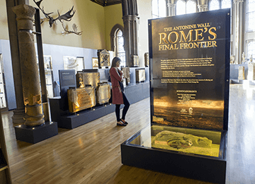 © Donald MacLeod
The Antonine Wall: Rome’s Final Frontier Gallery, Hunterian Museum. A high-ceilinged room filled with exhibits and columns. © Donald MacLeod
The Antonine Wall: Rome’s Final Frontier Gallery, Hunterian Museum. A high-ceilinged room filled with exhibits and columns.