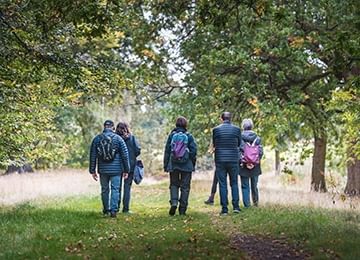 © Rediscovering the Antonine Wall Project
A group of people walk along a grassy woodland path. There are broadleaved trees with green foliage on both sides of them. © Rediscovering the Antonine Wall Project
A group of people walk along a grassy woodland path. There are broadleaved trees with green foliage on both sides of them.