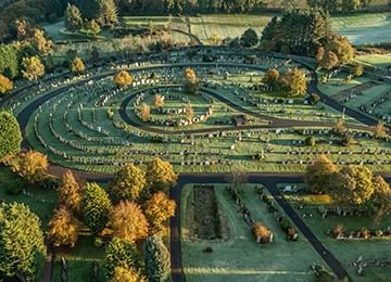 © Rediscovering the Antonine Wall Project
New Kilpatrick cemetery from above. The exposed section of wall base is in the foreground. It is made of cobbles. © Rediscovering the Antonine Wall Project
New Kilpatrick cemetery from above. The exposed section of wall base is in the foreground. It is made of cobbles.